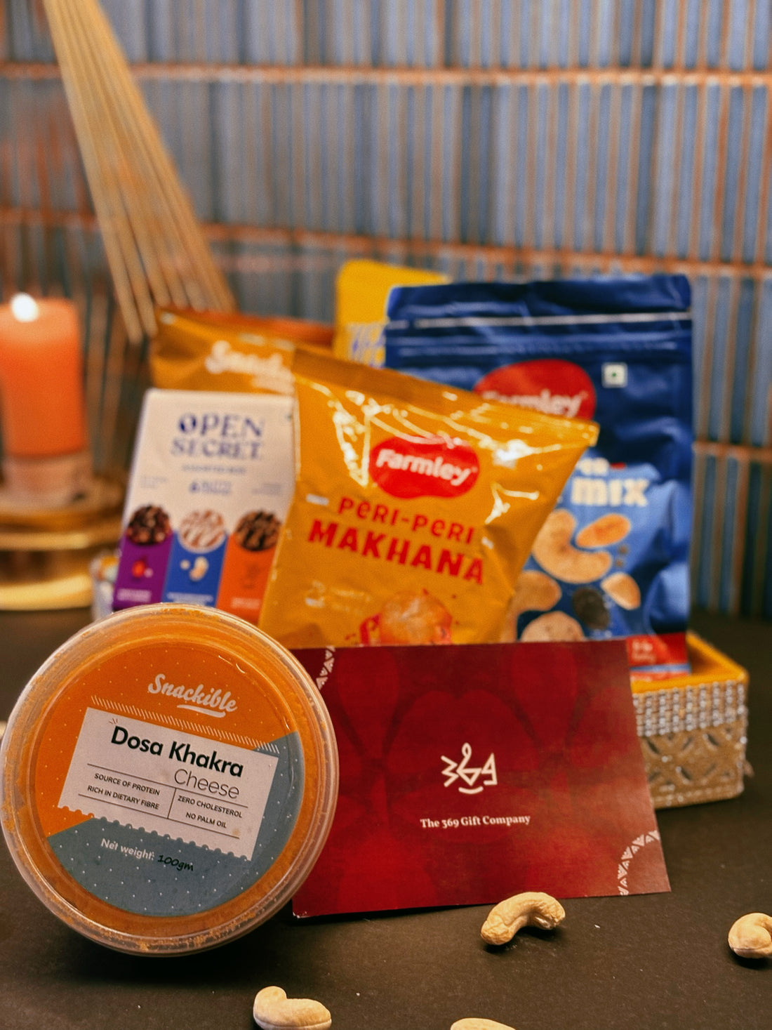 Gourmet artisanal wedding & event snack hamper by The 369 Gift Company featuring Open Secret treats, 4700 BC caramel popcorn, Snackible dosa khakra, cheese & peri peri popcorn, Farmly roasted peri peri makhana, Snackible ragi chips, and Farmly salt & pepper nut mix. Perfect for gifting and celebrations.