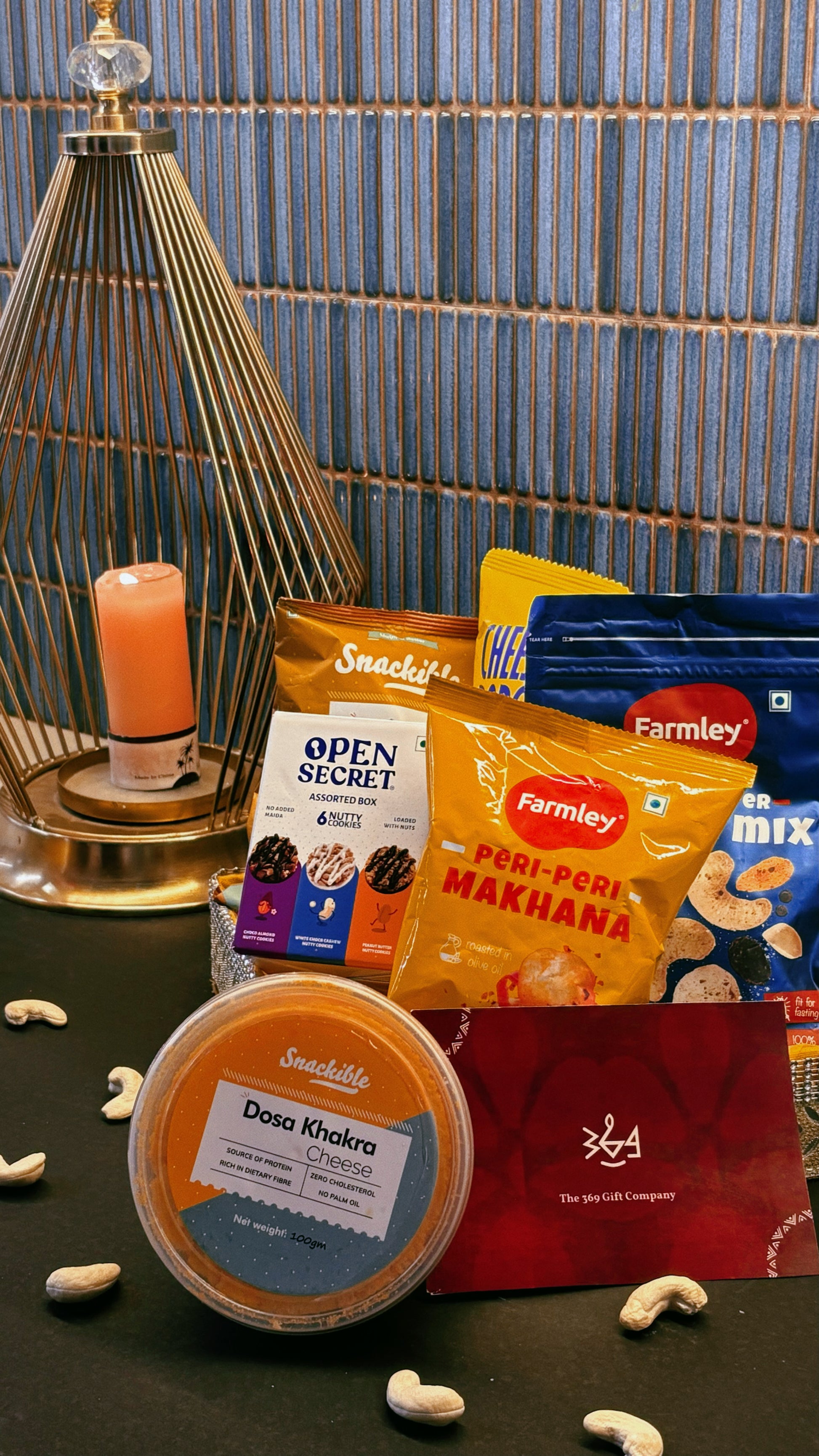 Gourmet artisanal wedding & event snack hamper by The 369 Gift Company featuring Open Secret treats, 4700 BC caramel popcorn, Snackible dosa khakra, cheese & peri peri popcorn, Farmly roasted peri peri makhana, Snackible ragi chips, and Farmly salt & pepper nut mix. Perfect for gifting and celebrations.
