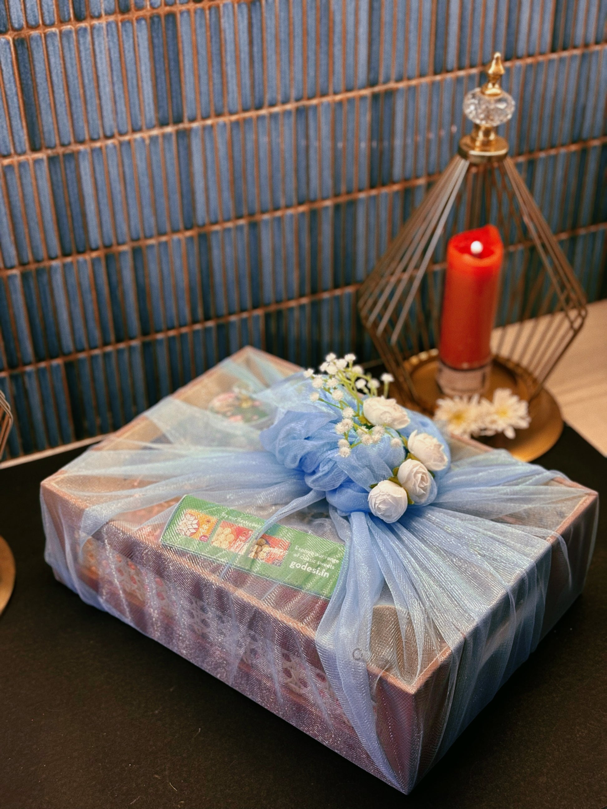 Luxury handcrafted wedding and event hamper by The 369 Gift Company — featuring a rattan tray with mocha leather detailing, Mysore pak, Urli Oudh candle, elephant tealight holders, nuts and seed-filled Pichwai metal jar, festive mints, rainbow crochet charm, starter bowls, and glass coffee tumbler — perfect for wedding favours, event gifting, and festive celebrations.